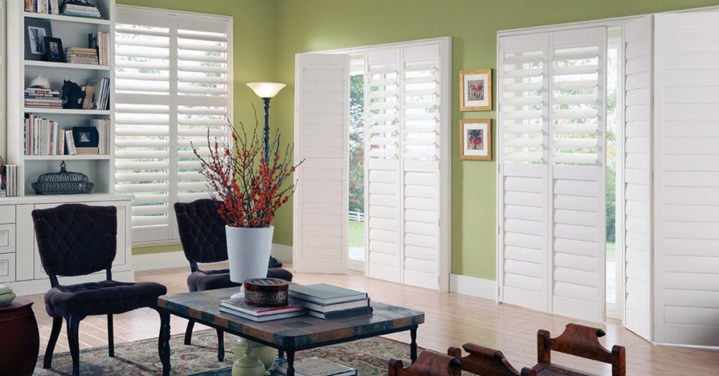 Alta Window Fashions Eclipse Shutters in Living Room with Casing 2 Panel Bi-fold